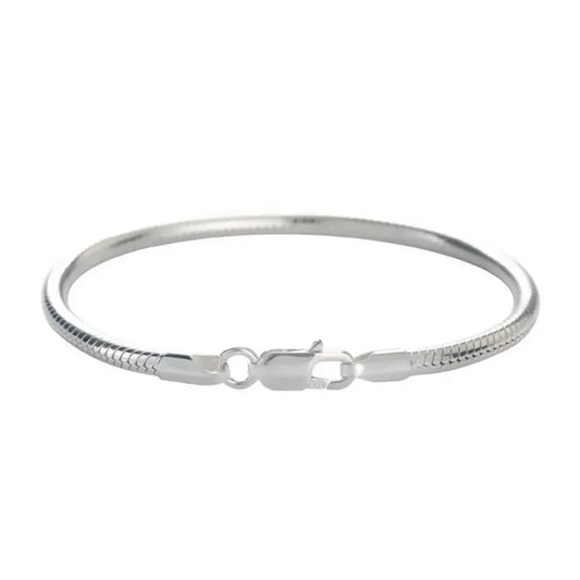 Silver snake chain bracelet laid flat in an oval on a plain white background.