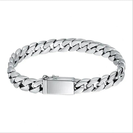Silver Cuban-link bracelet laid in an oval on a plain white background.