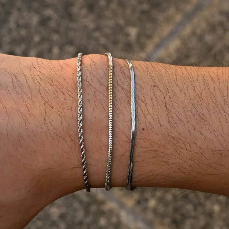 Three-piece stainless steel bracelet set for men with modern chain styles and adjustable extension clasps.