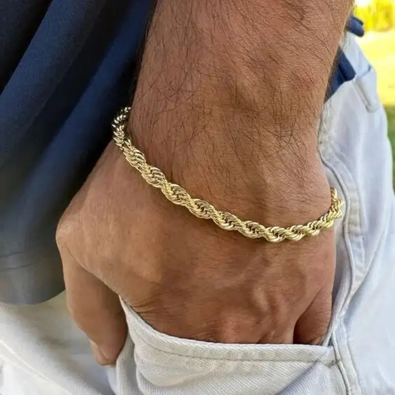 Gold stainless steel twisted rope chain bracelet worn on wrist