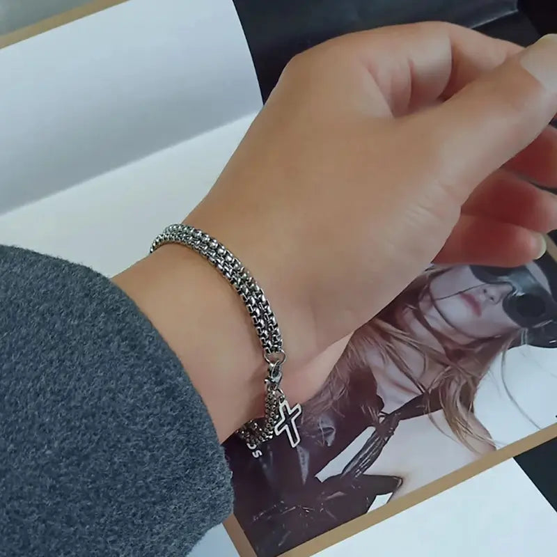 Close-up of double chain cross bracelet worn on wrist