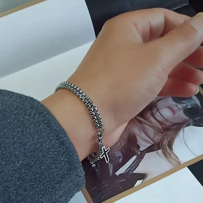Close-up of double chain cross bracelet worn on wrist